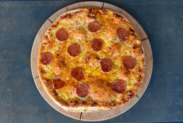 Homemade pizza with meatball on  wood background. Tasty pizza with meat and cheese. Italian pizza in rustic style. 