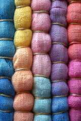 Colorful bundles of fabric arranged neatly in a vibrant display showcasing craftsmanship and textile artistry