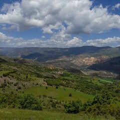 Naklejka premium A lush green landscape surrounded by mountains from Koyulhisar district of Sivas city of Turkey