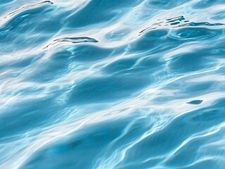 Close-up of calm blue water surface with ripples and reflections in high resolution.
