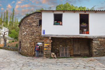 way of st james to Compostela , pilgrim woman reading informative poster