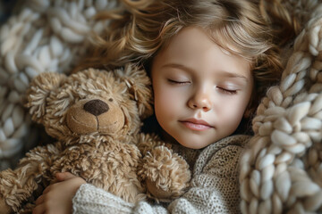 a little girl with blond curly hair sleeps hugging a teddy bear 