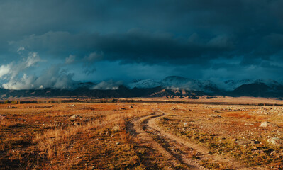 Obraz premium Picturesque landscape with snowy high mountains in autumn, dramatic weather