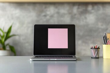 Laptop with a blank screen and pink sticky note on a clean desk on modern workspace