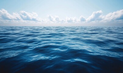 Fototapeta premium Calm ocean surface under a bright blue sky with fluffy clouds.