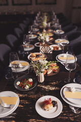 bright and festive table in the restaurant hall. Table setting in the restaurant. Brunch table setting with different delicious food ready for friends home party. A variety of food on the table