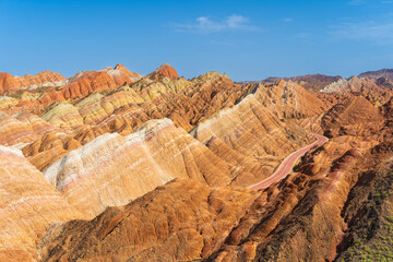 Under the clear sky, the colorful Danxia landforms