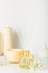 Aromatic reed air freshener on wooden table.Diffuser with natural fruity, floral, spicy aroma.interior scent. Luxury perfume for the home.Orange, lime, coffee, cinnamon, star anise, vanilla and orchid