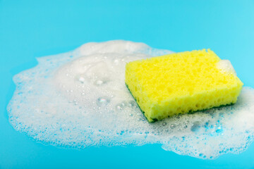 Colorful dish sponges on textured background. Kitchen sponge. Cleaning concept, cleaning service. Dishwashing liquid with clean and dirty dishes plate. Place for text, copy space. Wash the dishes.