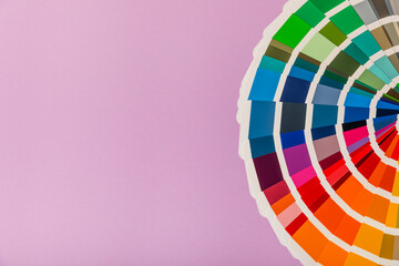 Obraz premium Color palette on a bright colored background. Color palette guide. paper catalog of rainbow color. creative.Palette, samples of trending colors. Color swatches. Decor and interior designer. Top view. 