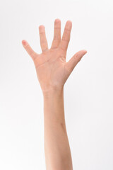 Obraz premium Close-up view of a person's hand raised with fingers spread wide. The hand and forearm are light-skinned, set against a plain white backdrop.
