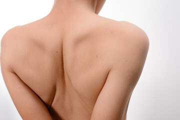 A detailed image showcasing the back and shoulders of a person, highlighting skin texture and form....