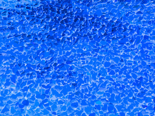 Garden decoration with blue stones background. Small blue stones pattern among small blue stones. Seamless stone floor. blue stones seamless pattern. Deeply stone texture.