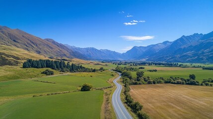 Empty asphalt road and green grassland and mountain under blue sky 