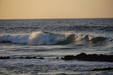 Autumn afternoon watching the sunset and waves from the cliff