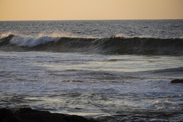 Autumn afternoon watching the sunset and waves from the cliff