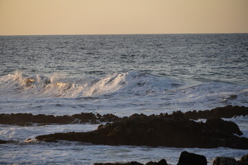 Autumn afternoon watching the sunset and waves from the cliff