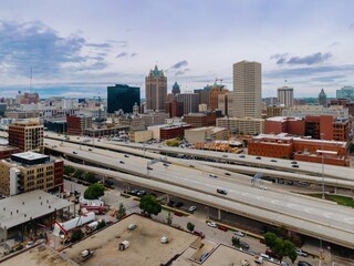 High-angle view of Milwaukee city skyline and highway construction. Urban development and...