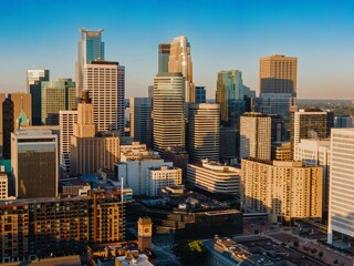 High-angle view of Minneapolis skyline at sunrise. Modern skyscrapers and city streets. Urban landscape. Downtown West, Minneapolis, Minnesota, United States