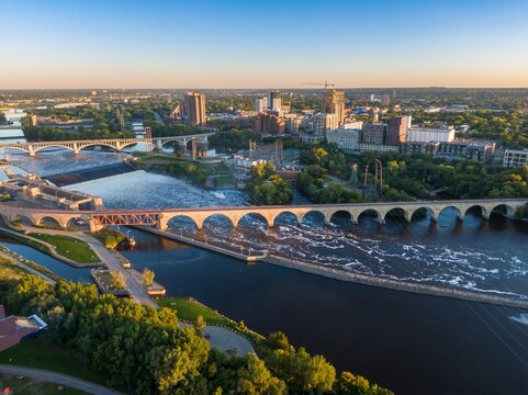 Aerial view of the St. Anthony Falls and bridges in Minneapolis, MN at sunset. City skyline and river rapids visible. Mississippi River, Minneapolis, Minnesota, United States