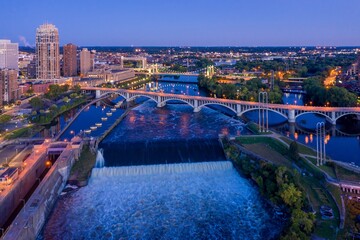 Evening view of the St. Anthony Falls Lock and Dam in Minneapolis, MN. City skyline and bridge in the background. Beautiful twilight colors. Upper Dam, Minneapolis, Minnesota, United States