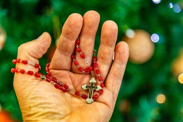 Creative photo of a Catholic rosary with red ruby ​​beads