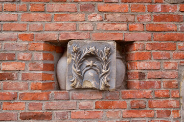 Red brick wall with stone art decor.