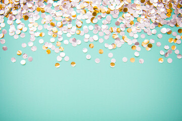 cascading silver confetti on mint green surface, party invite, space for text