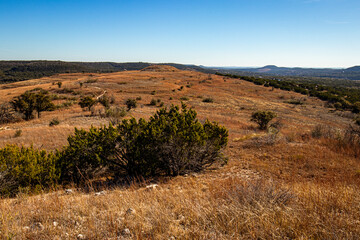 Hills and expansive fields of the Balcones Canyonlands Wildlife Refuge in the Texas Hill Country. the scene extends into distant hills and a wide valley. 