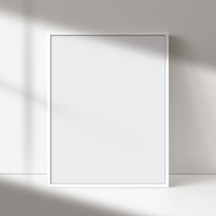 White picture frame art, poster, or painting mock-up with blank canvas, soft natural light, and shadow on a neutral wall. Perfect for showcasing artwork or designs.