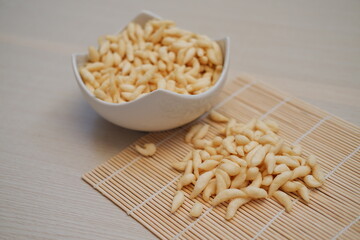 telur gabus sticks on white bowl with wooden table
