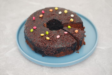 Chocolate cake on plate with marble background