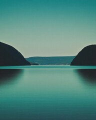 Serene landscape featuring calm waters between two hills.