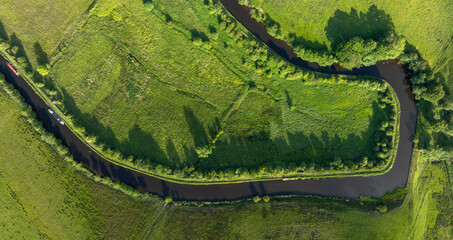 This captivating drone shot reveals a picturesque rural landscape characterized by its lush...