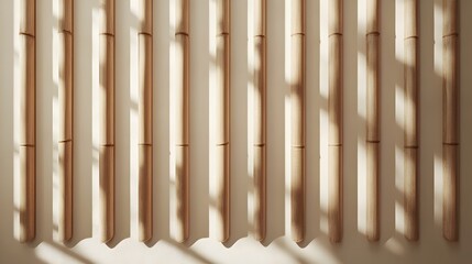 Sunlight illuminates a wall of vertical bamboo poles