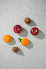 A vibrant orange, apple and snakefruit isolated on a clean white background, representing freshness, health, and natural citrus goodness, ideal for food related visuals