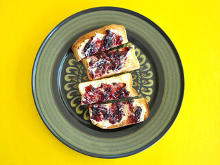 Toasted white bread with butter and blackberry jam.