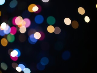 Fototapeta premium Abstract background of shimmering gold, blue, and black lights in a de focused style, festive, de focused