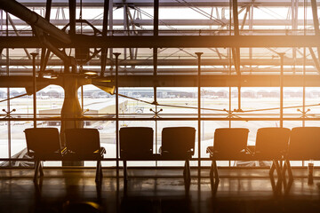 Waiting in the airport, backlit perspective, silhouettes of people waiting for travel at the airport, Travel and waiting for visits