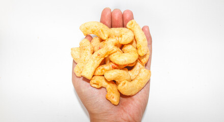 Hand holding fried macaroni spread isolated on white background. Savory fried macaroni in Indonesia