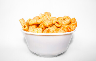 Fried macaroni served in a white bowl isolated on white background. Savory fried macaroni in Indonesia