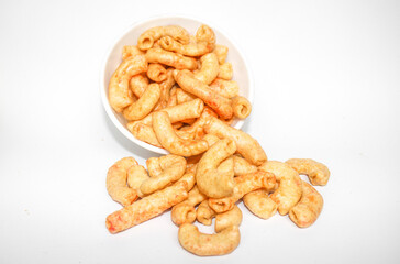 Fried macaroni served in a white bowl isolated on white background. Savory fried macaroni in Indonesia