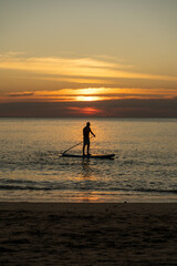 Fototapeta premium silhouette of a paddle boarder on the sunset