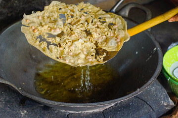 popular Indonesian traditional food or snack is known as rempeyek. Rempeyek is made from rice flour mixed with water to form a thick dough and then fried thinly. Peanut brittle with chopped peanuts.