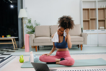 African Woman Doing Yoga and Watching Online Tutorials on Laptop, Training