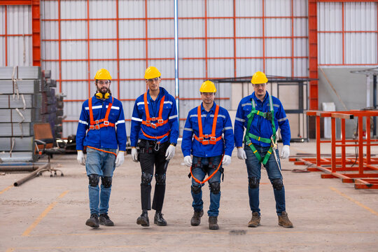 Teamwork worker wearing safety uniform using digital tablet inspect product iron metal on shelves in warehouse. Engineer worker stainless inspecting in storage logistic factory.