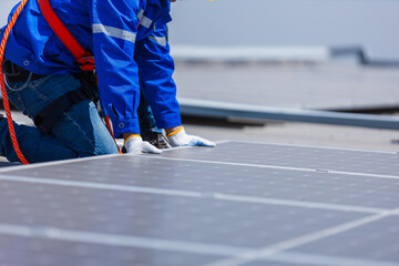 Fototapeta premium Technicians are installing and inspecting standards of solar panels on roof of an industrial factory. Electrical energy obtained from nature sunlight clean renewable energy.