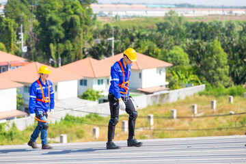 Engineer set installation and inspect standards of solar panels on roof of an industrial factory. Team technician inspection repair technology solar cell. Alternative innovation power environmental.