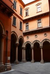 Elegant Historic Courtyard with Archways and Warm Orange Facade