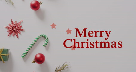 Image of snow falling over christmas greetings text and decoration © vectorfusionart